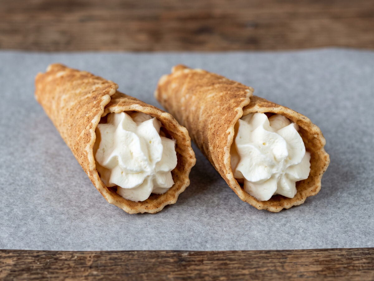 Knuspriges Waffelgebäck aus Brandenburg | Brandenburger Klemmkuchen | Feine Hörnchenwaffeln, warm gerollt und mit Sahne serviert